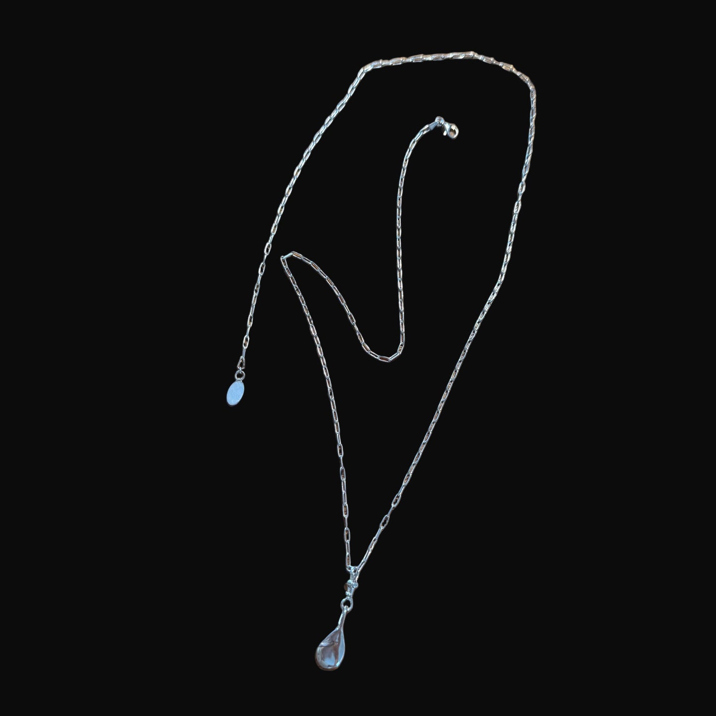 Silver necklace on a black background
