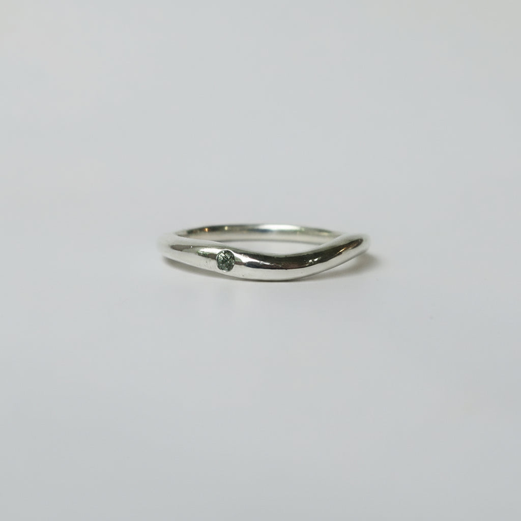 Silver ring on a light gray background