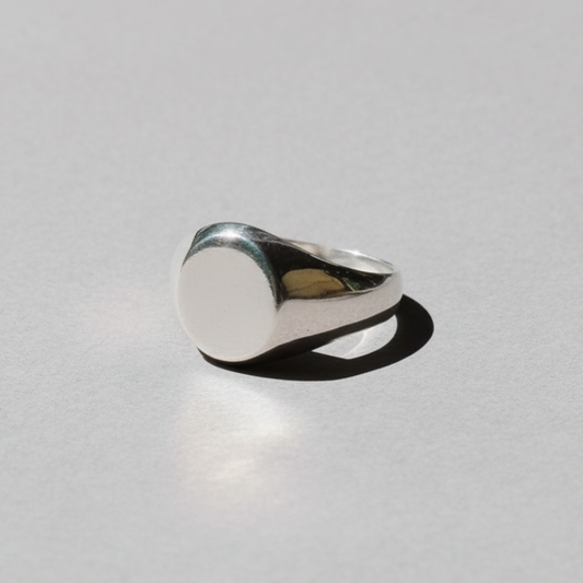 Silver ring on a light gray background