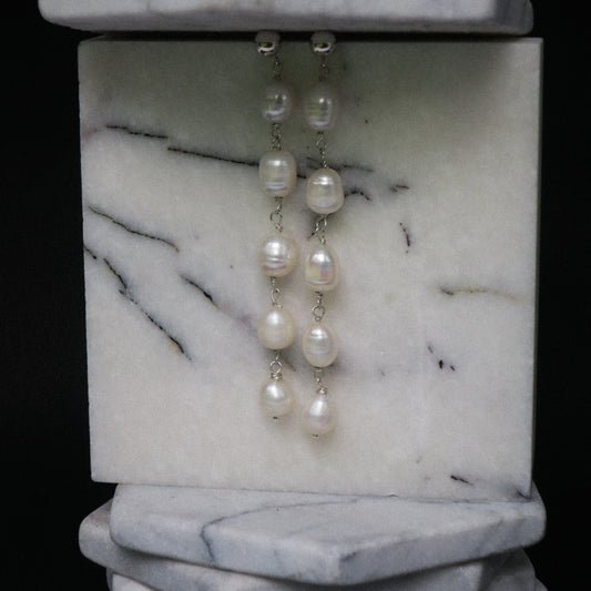 Pearl earrings on a marble stand