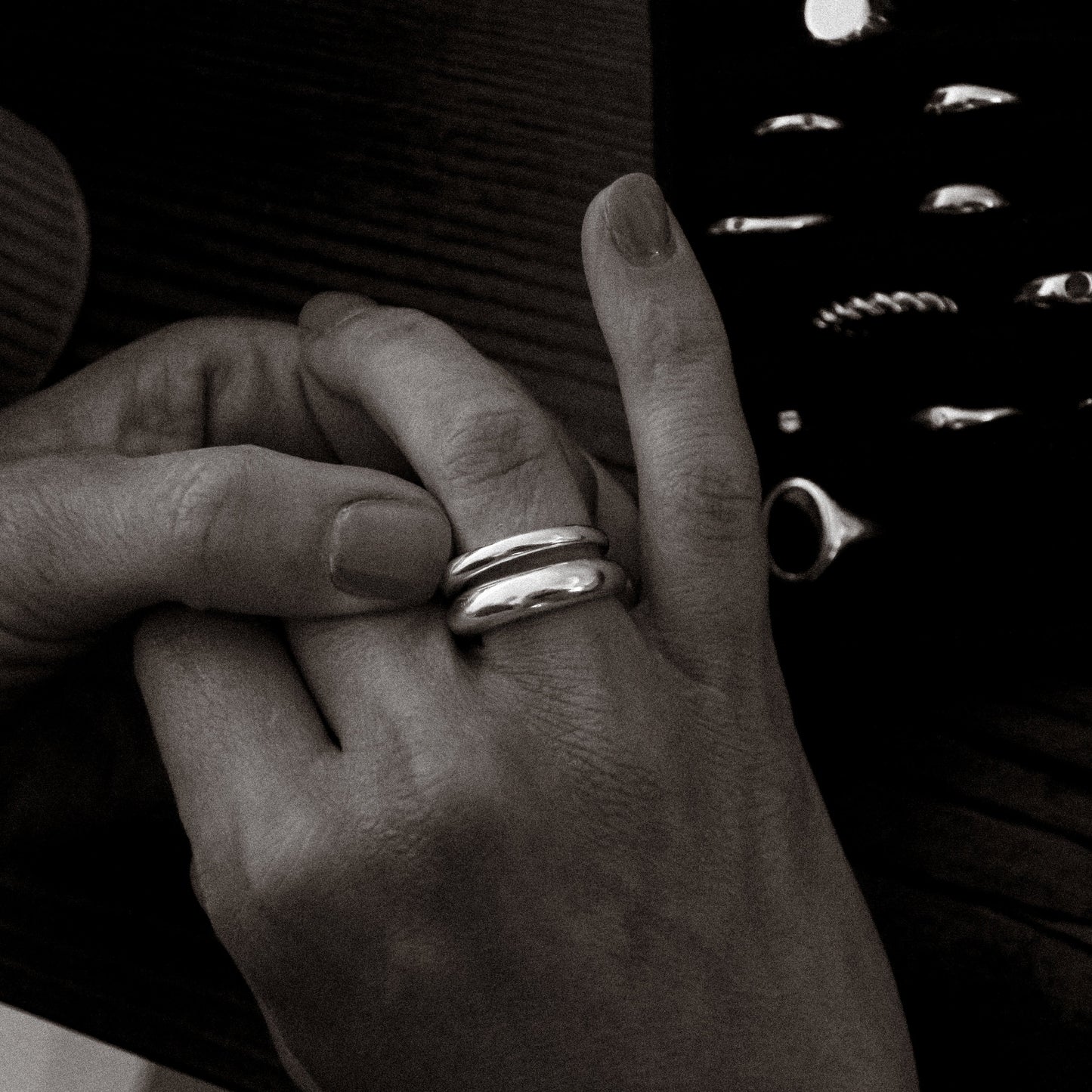 Close-up of a hand wearing a ring with a blurred background
