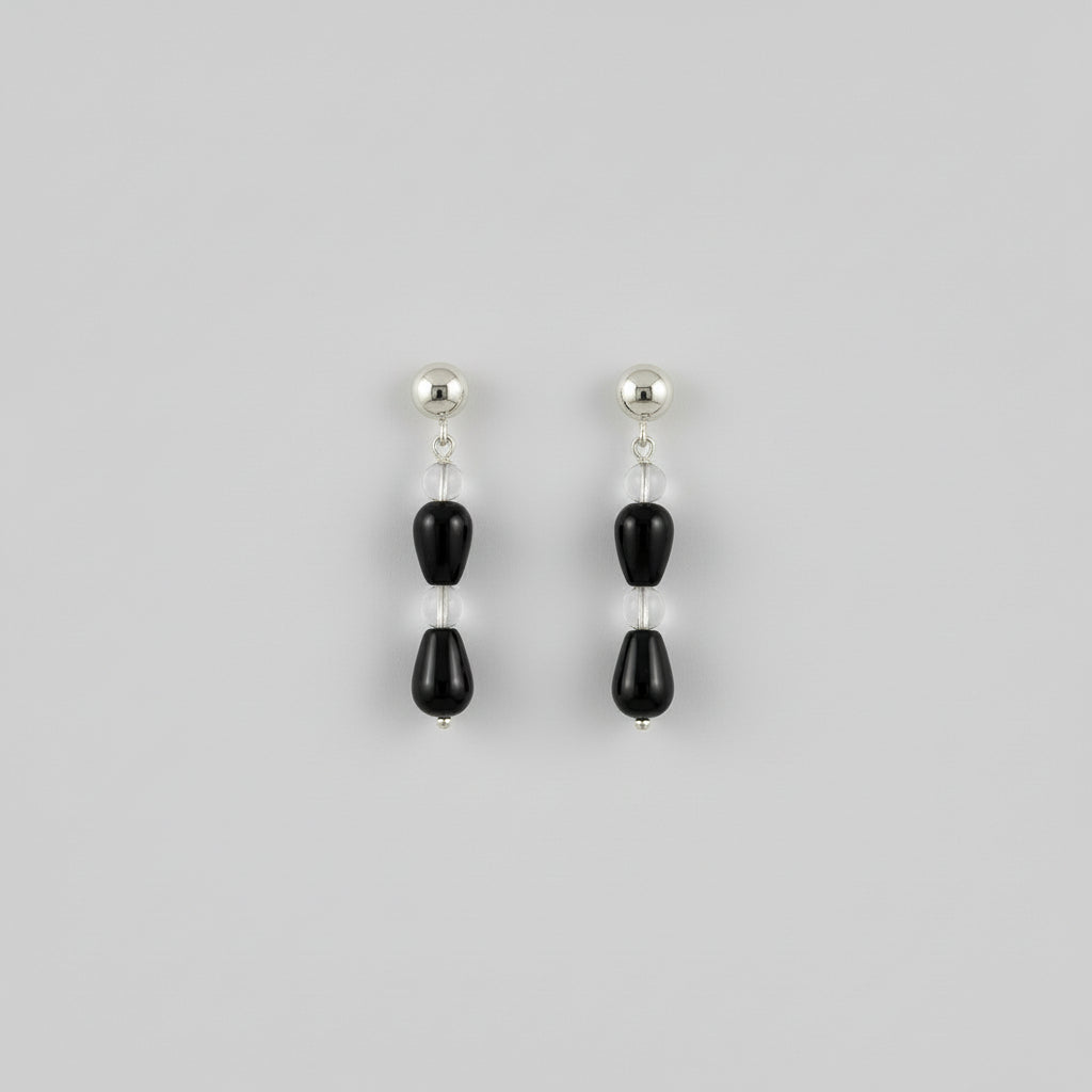 close up of a pair of earrings in a studio setting