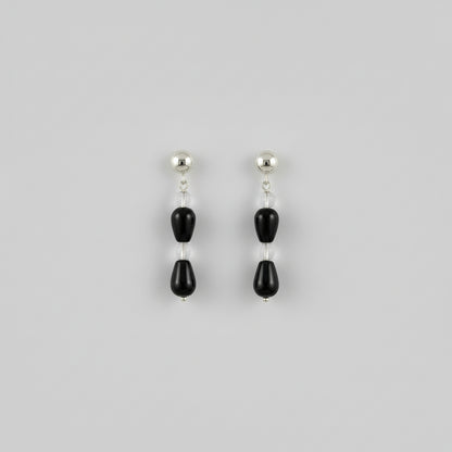 close up of a pair of earrings in a studio setting