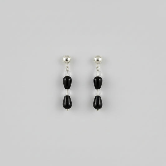 close up of a pair of earrings in a studio setting