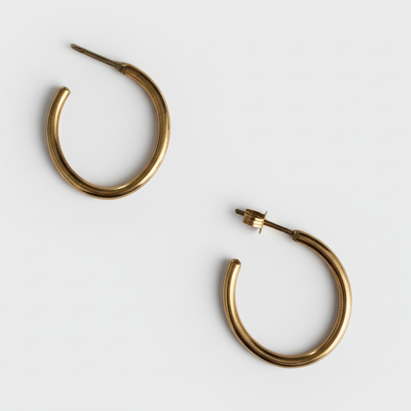 Pair of gold hoop earrings on a white background