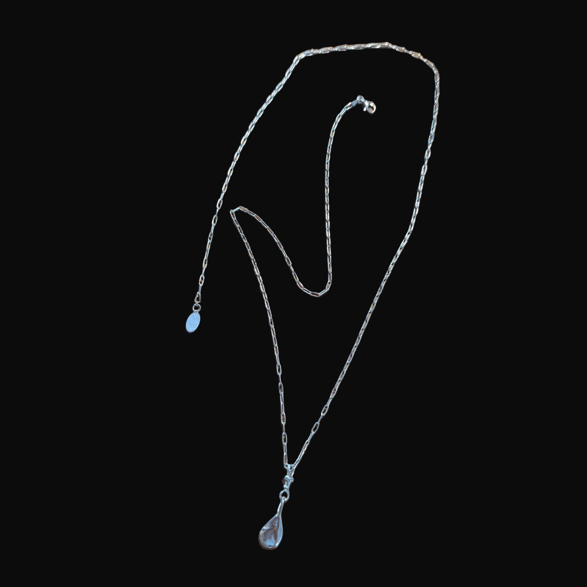 Silver necklace on a black background