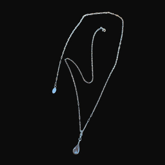 Silver necklace on a black background