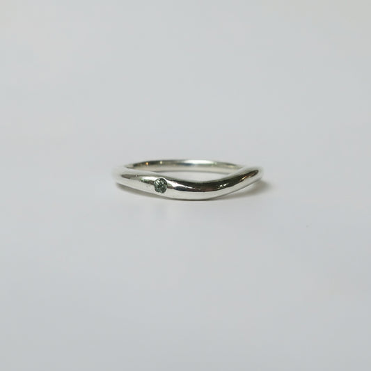Silver ring on a light gray background