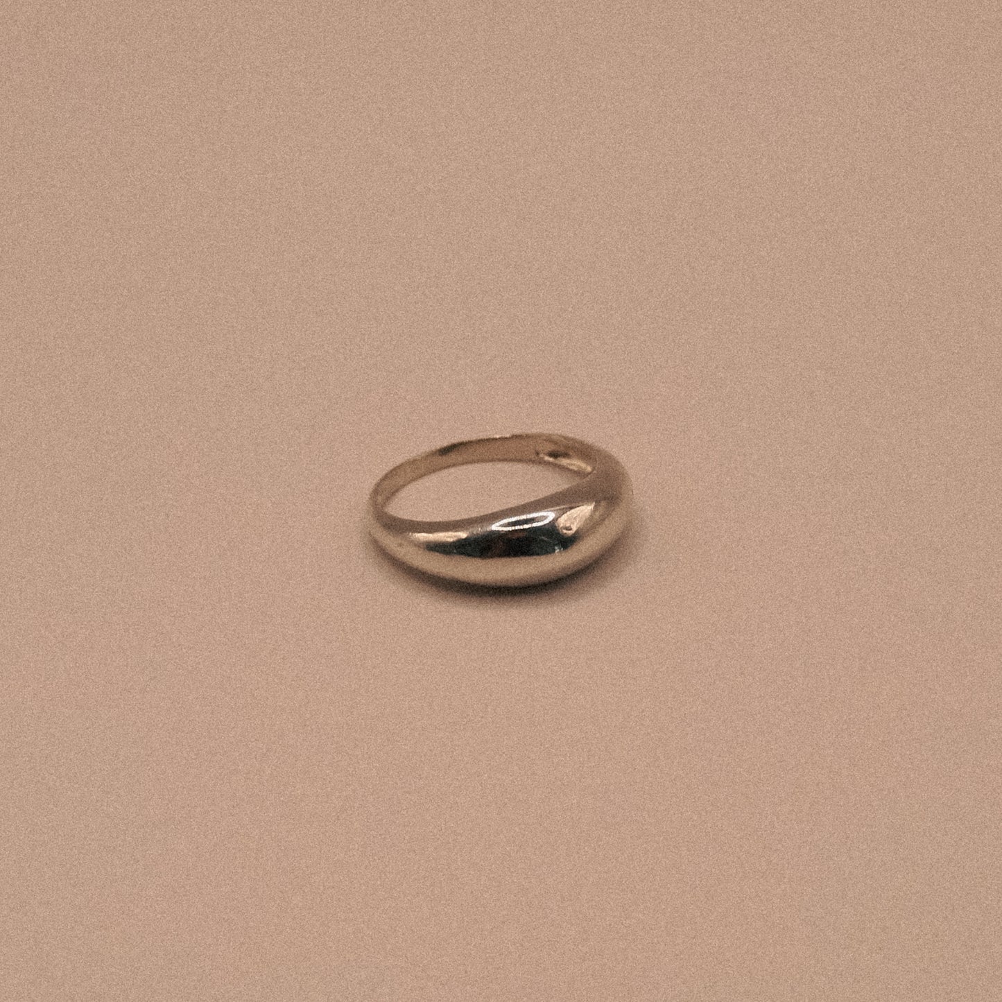 Silver ring on a beige background