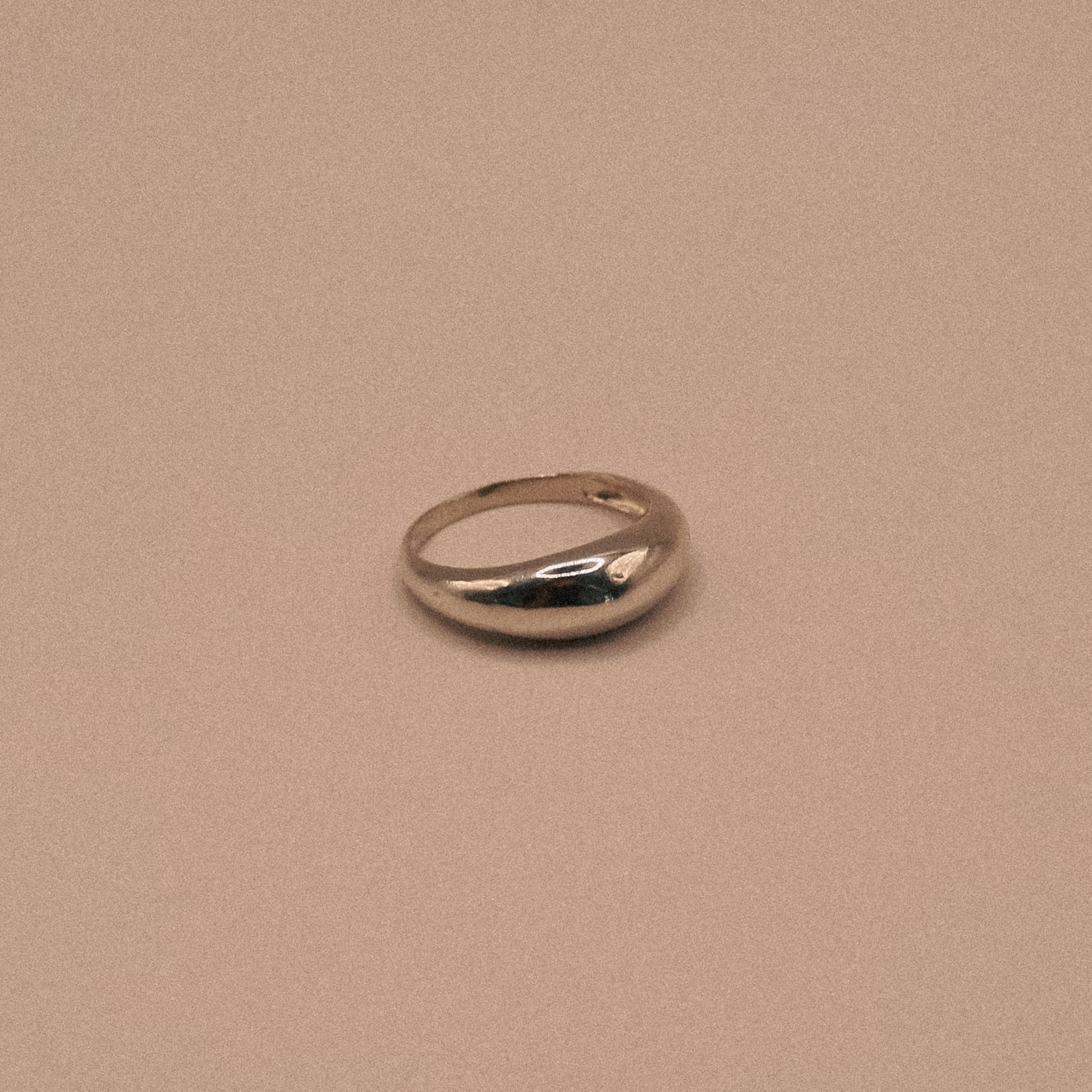 Silver ring on a beige background