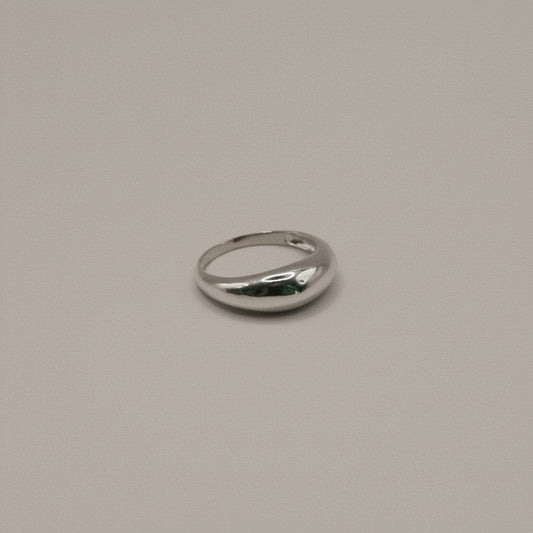 Silver ring on a beige background