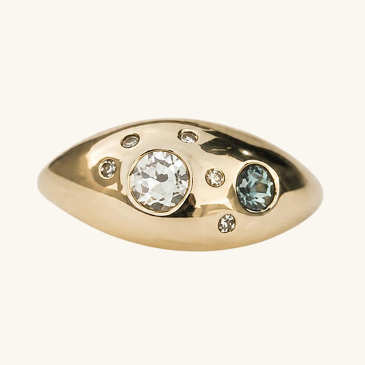 Gold ring with embedded gemstones on a white background