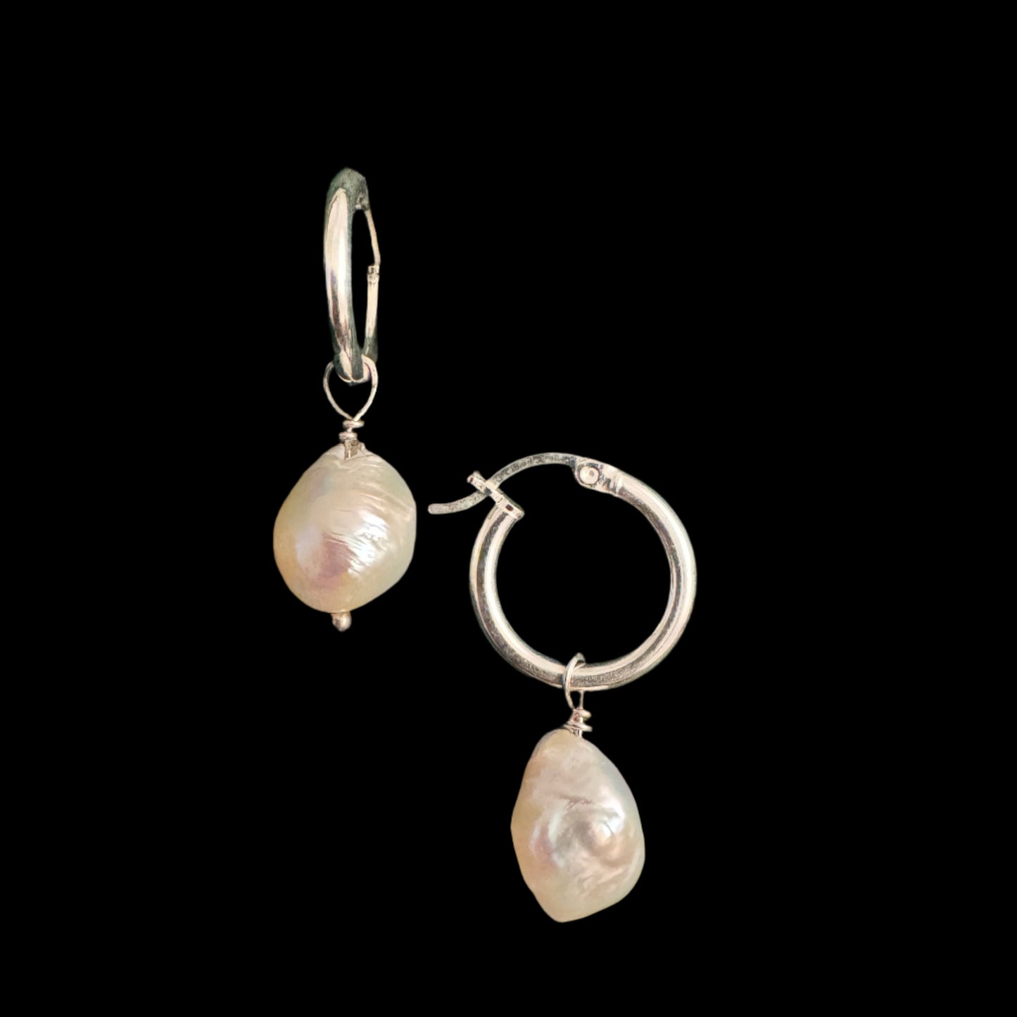 Pair of pearl earrings on a black background