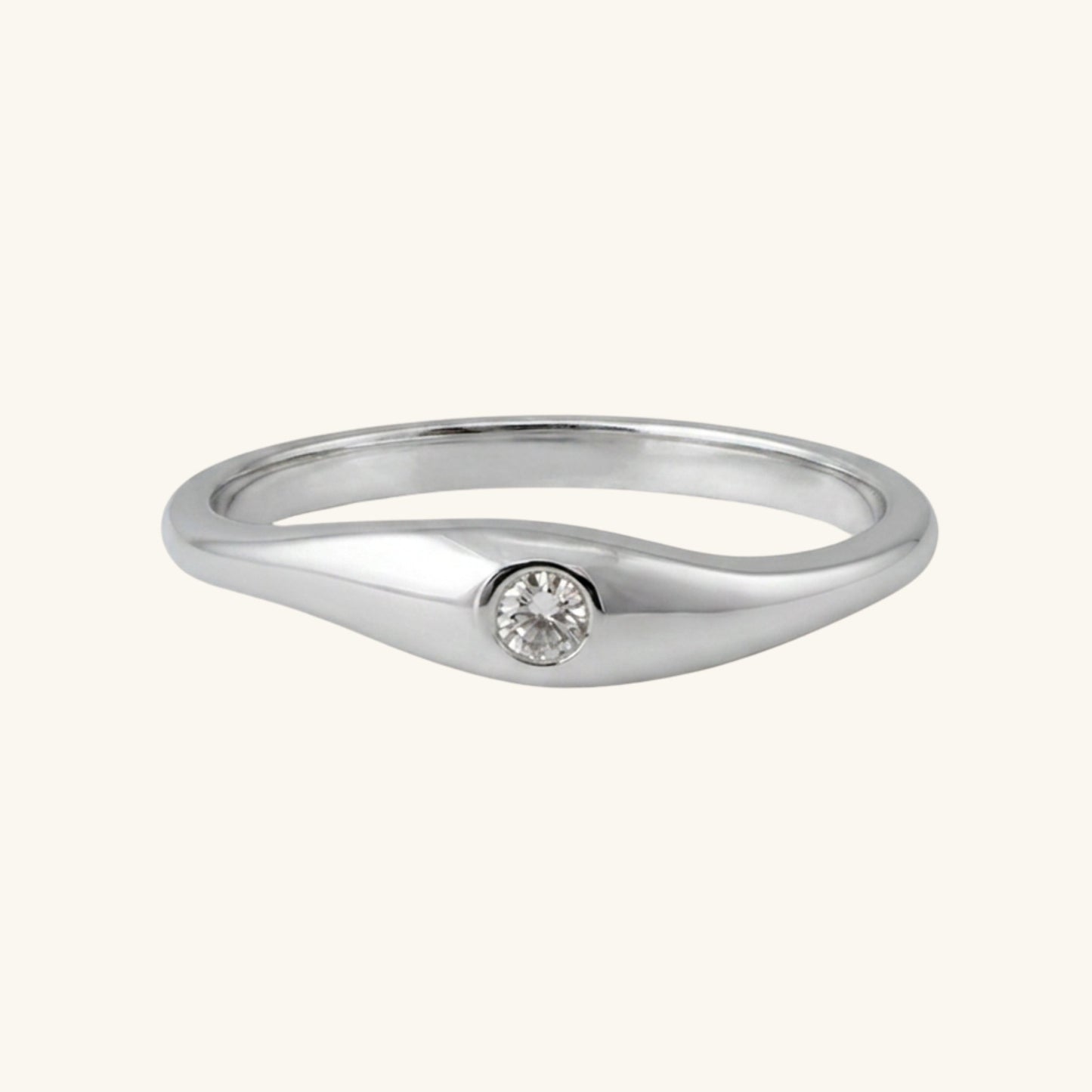 Silver ring with a small diamond on a white background