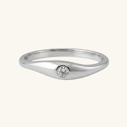 Silver ring with a small diamond on a white background