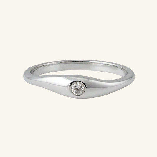 Silver ring with a small diamond on a white background