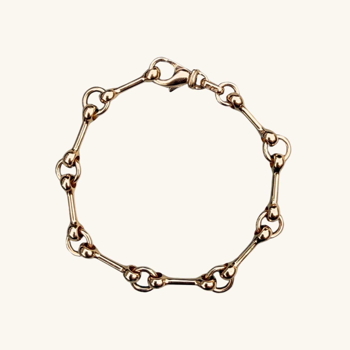 Yellow gold chain bracelet on a white background