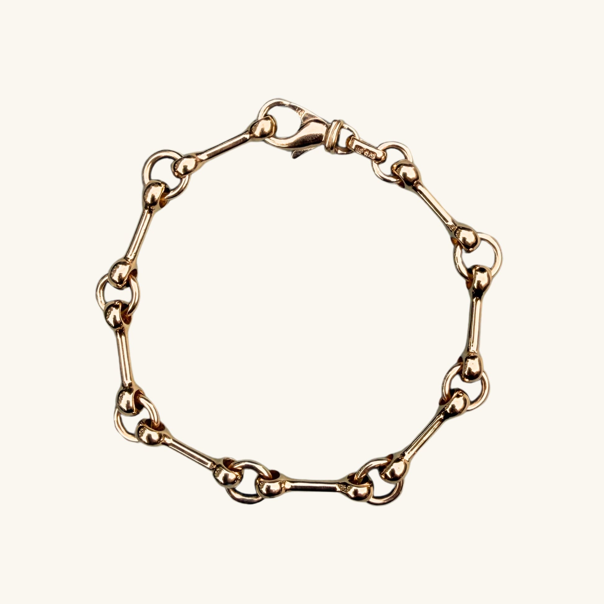Yellow gold chain bracelet on a white background