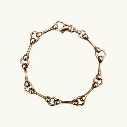 Yellow gold chain bracelet on a white background