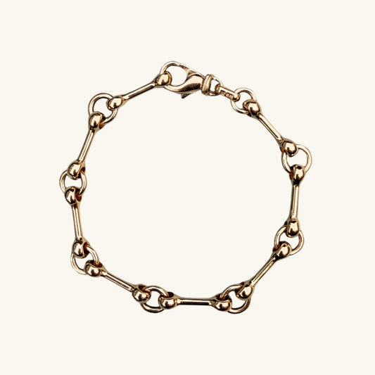 Yellow gold chain bracelet on a white background