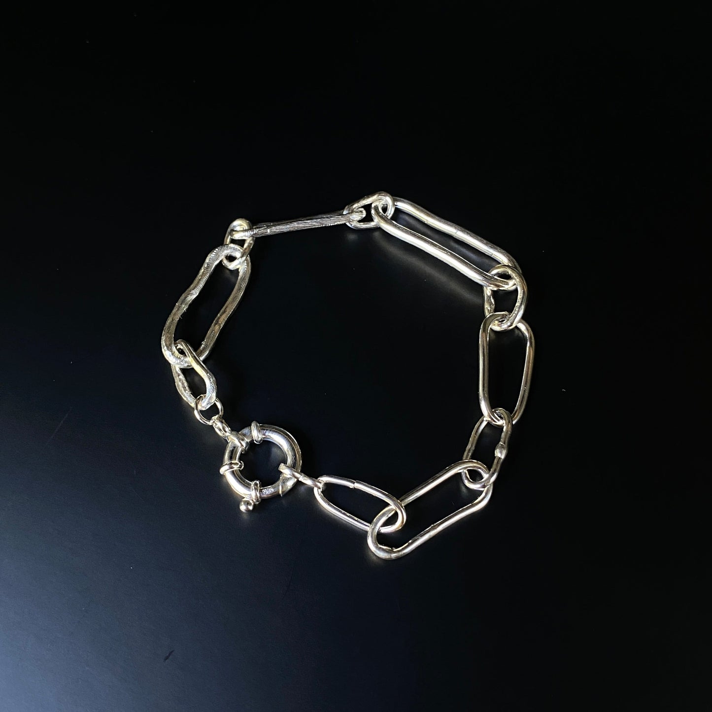 Silver chain bracelet on a dark background