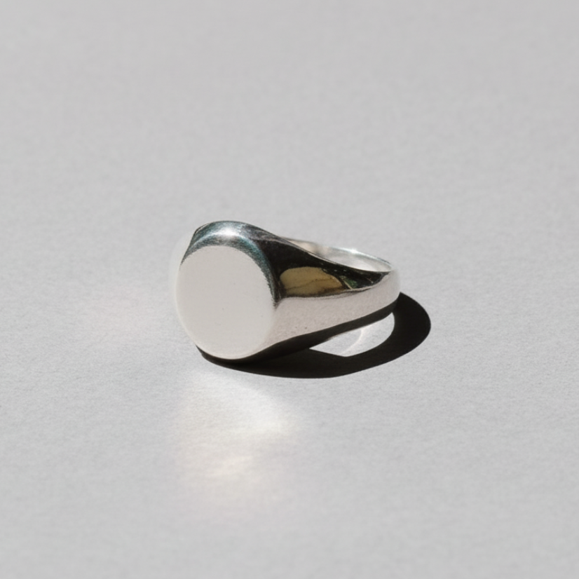 Silver ring on a light gray background