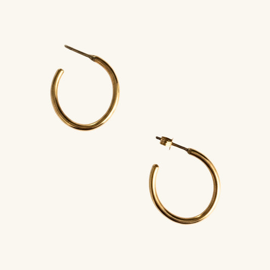 Gold hoop earrings on a white background