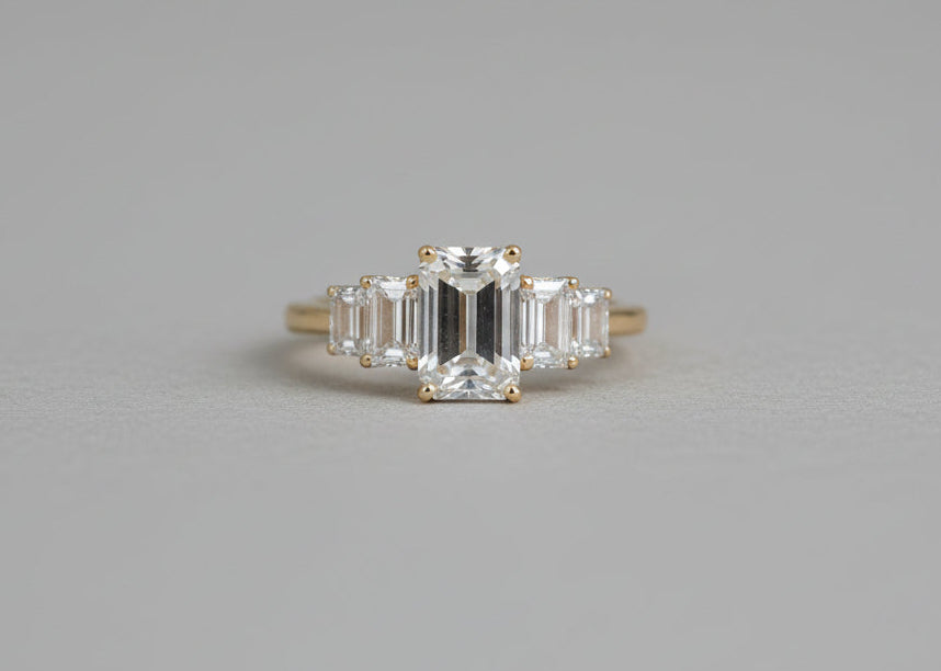 A diamond ring on a grey studio backround