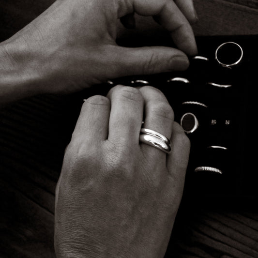 Close-up of hands with rings and selecting other pieces.