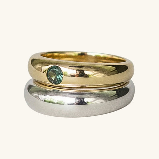 Gold and silver ring on a cream background