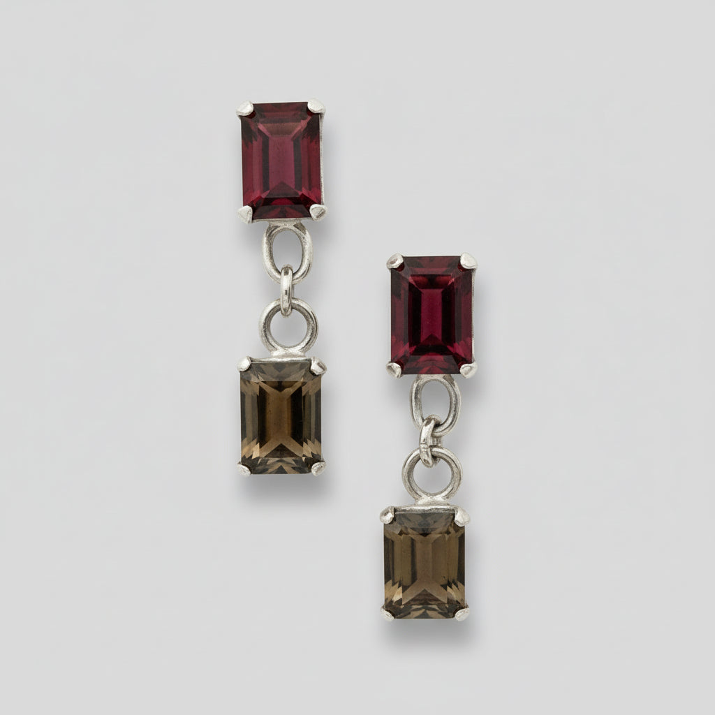 Pair of earrings with rectangular gemstones on a light background