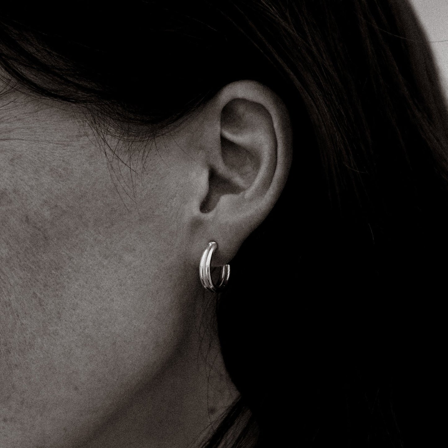 Close-up of a woman wearing earrings with a blurred background