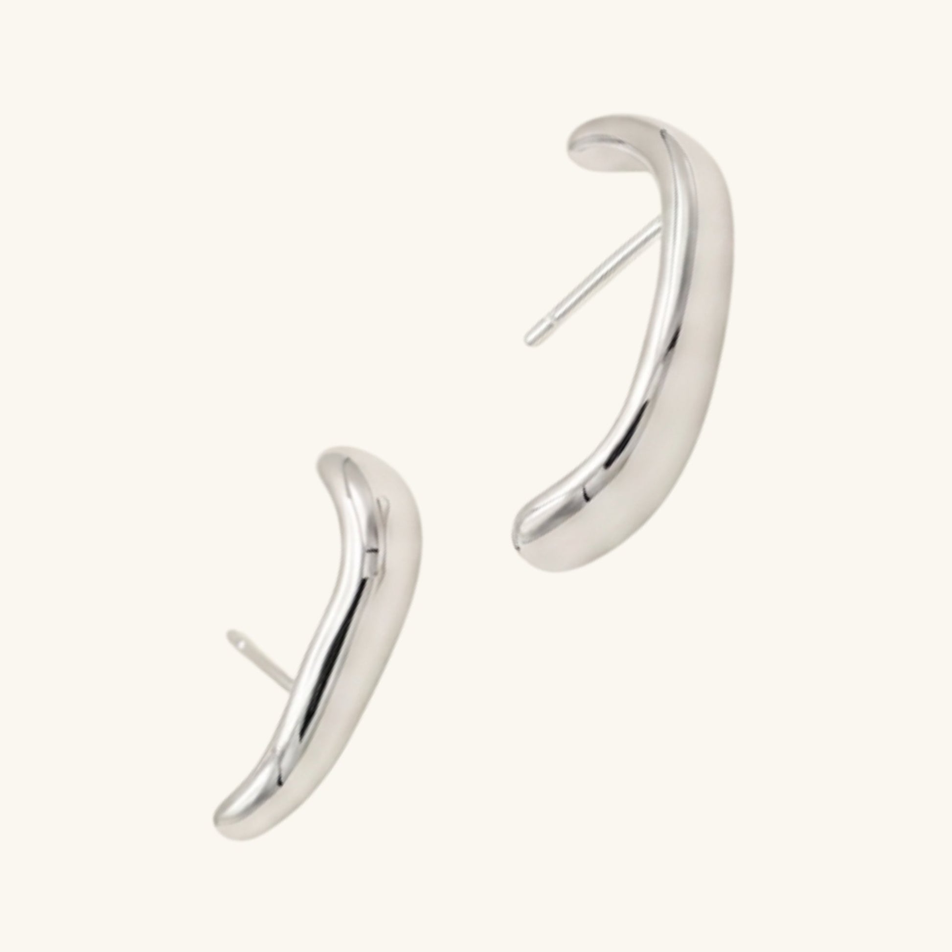 Pair of silver hoop earrings on a cream background