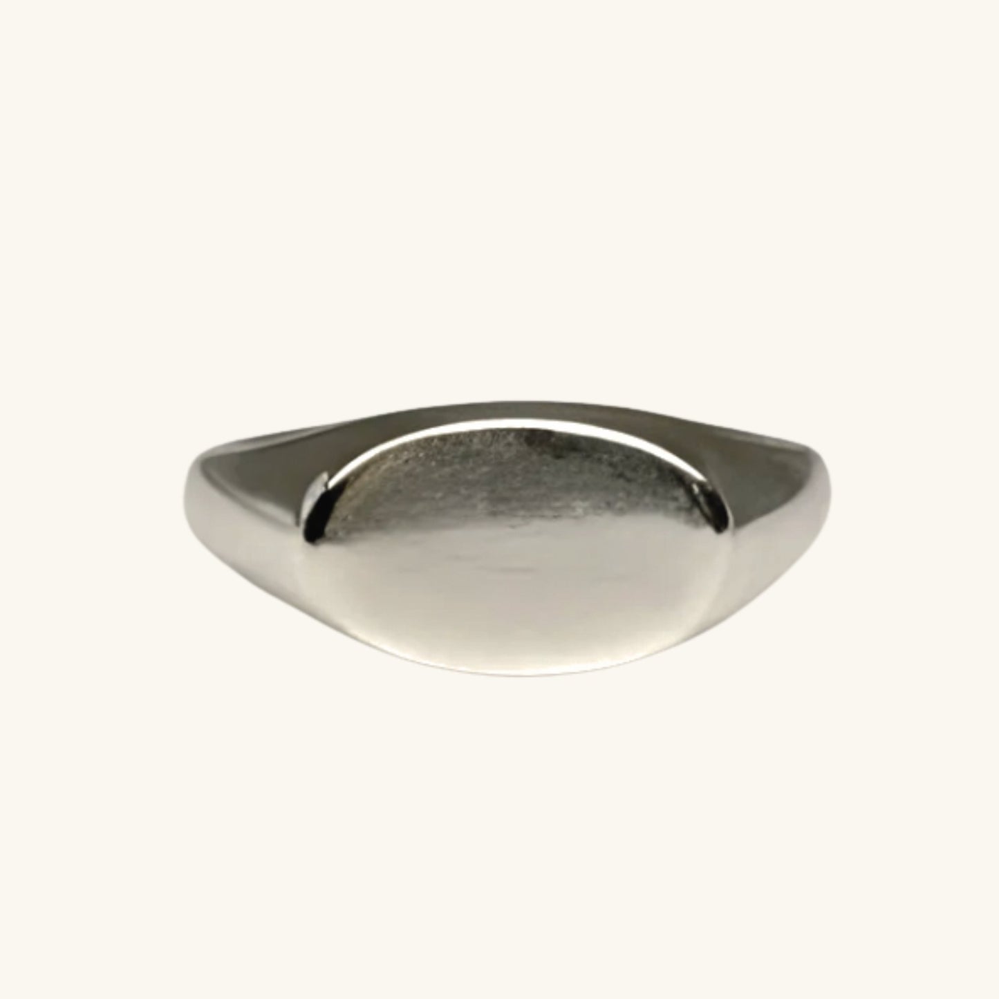 Silver ring on a cream background