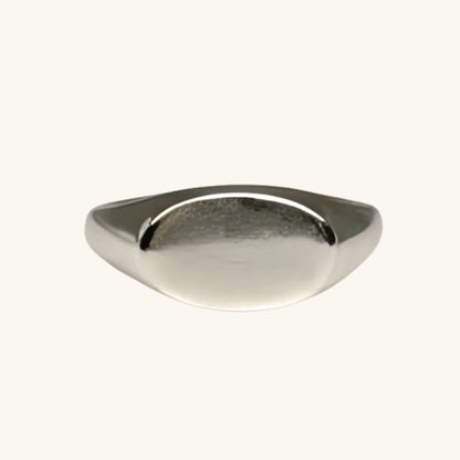 Silver ring on a cream background