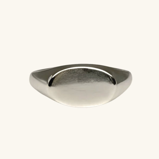 Silver ring on a cream background