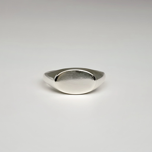 Silver ring on a light gray background