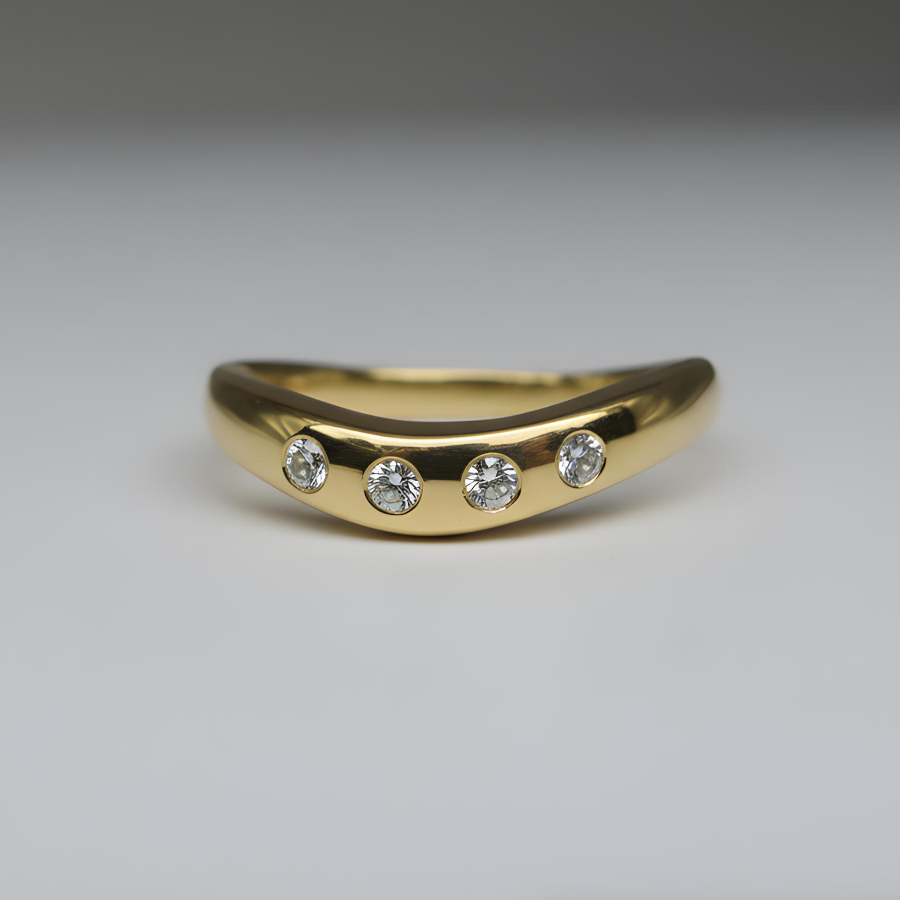 gold ring with four diamonds shot on a studio background