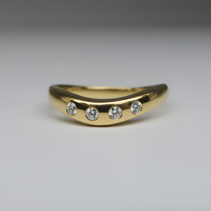 gold ring with four diamonds shot on a studio background