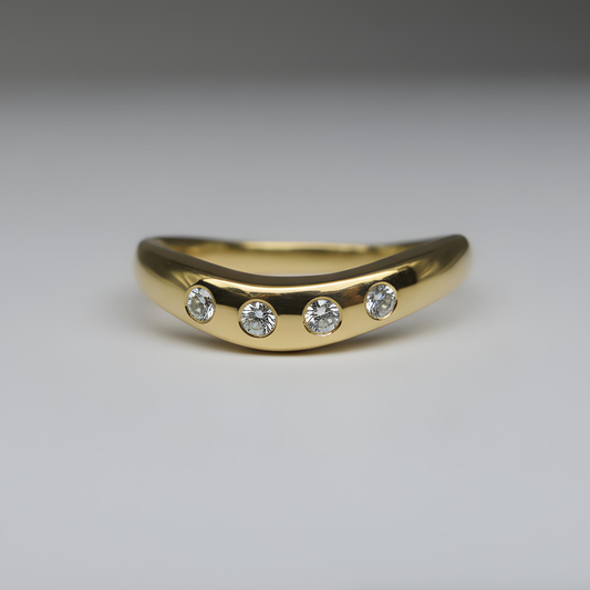 gold ring with four diamonds shot on a studio background
