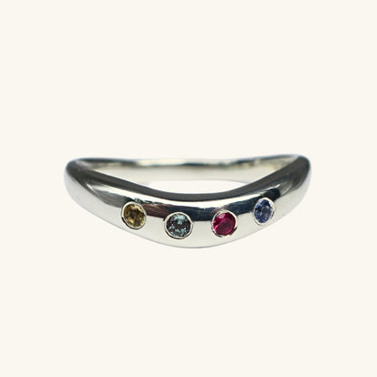 Silver ring with four gemstones on a white background
