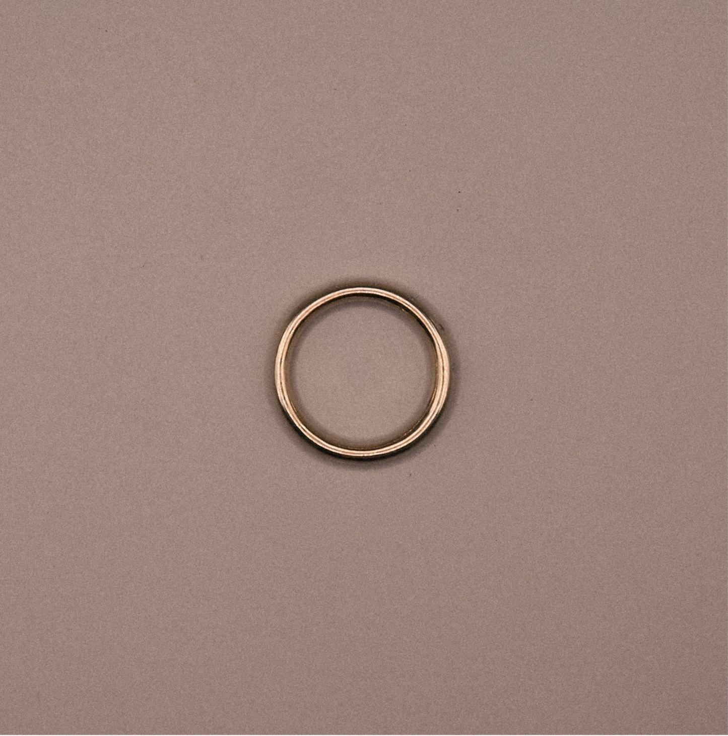 Gold ring on a beige background