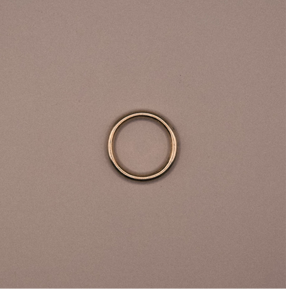 Gold ring on a beige background