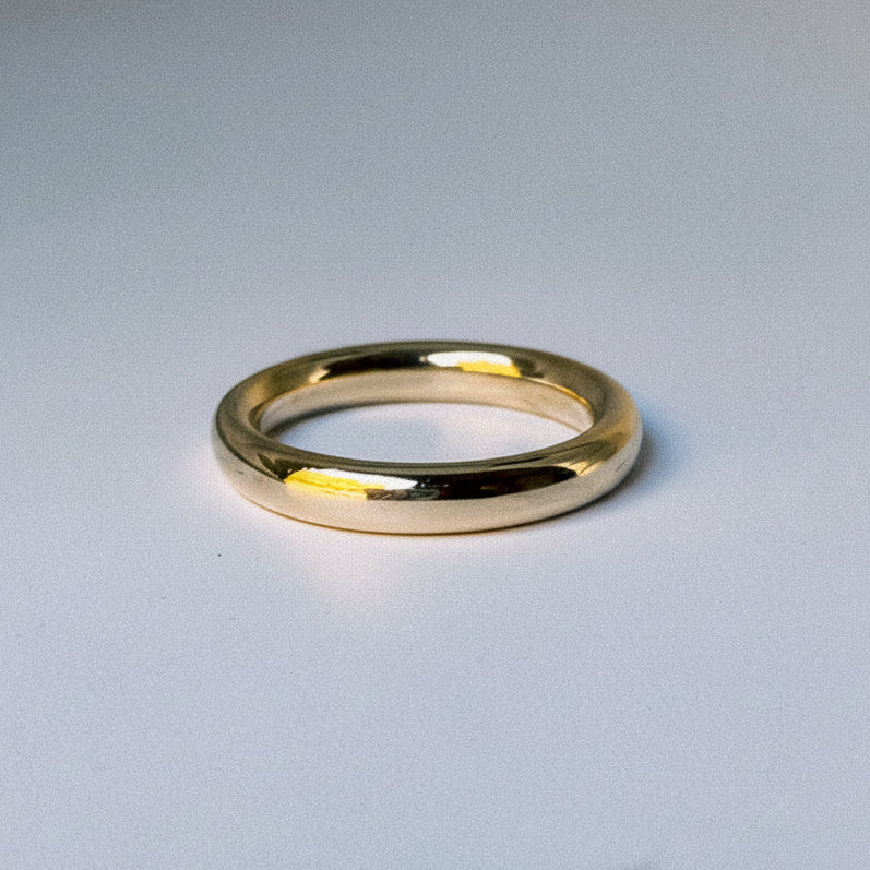 Gold ring on a light gray background