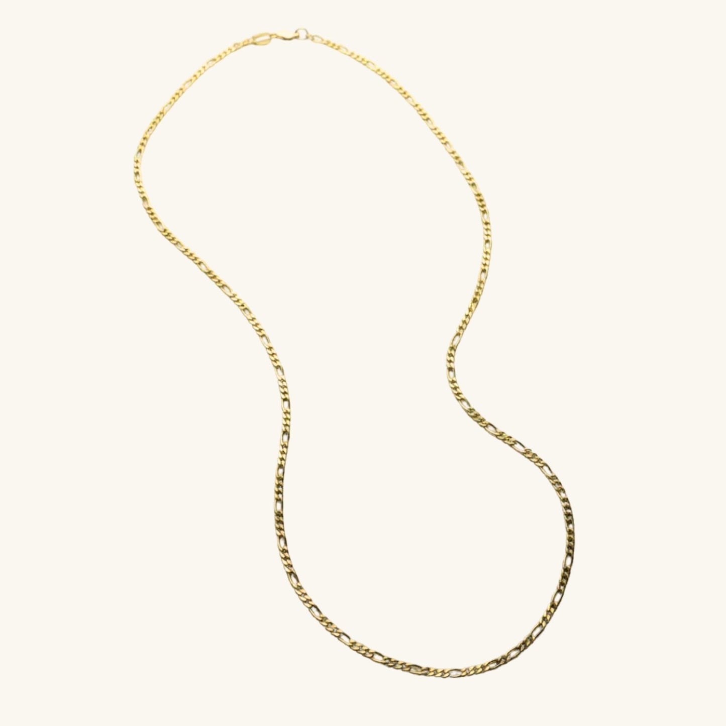 Gold chain necklace on a white background