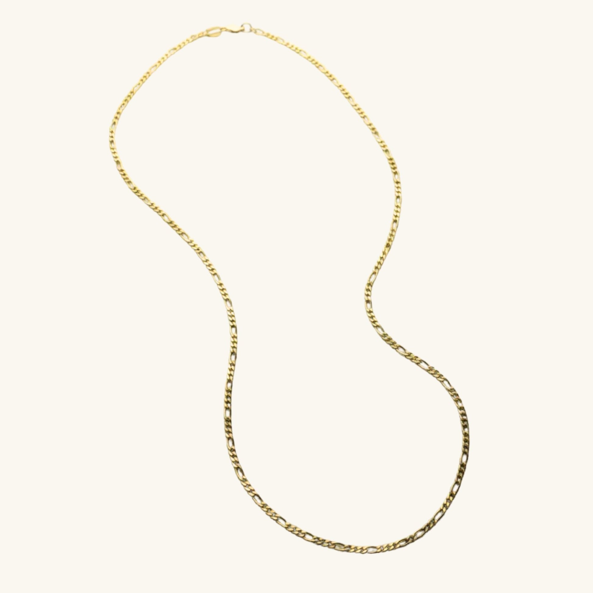 Gold chain necklace on a white background