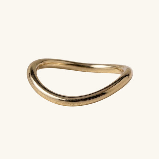 Gold ring on a cream background