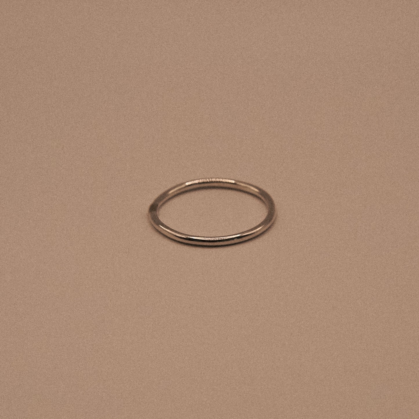 Silver ring on a beige background