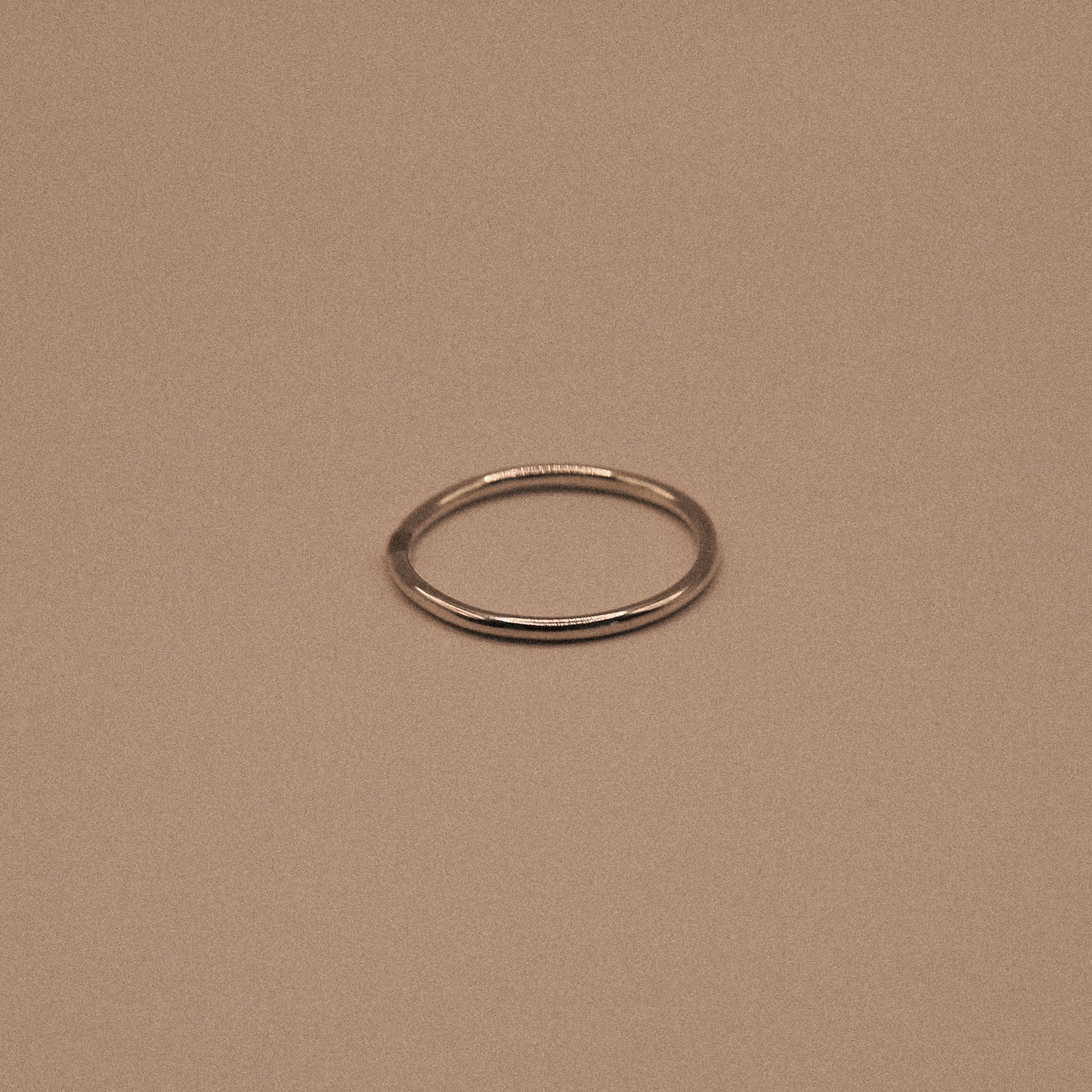 Silver ring on a beige background