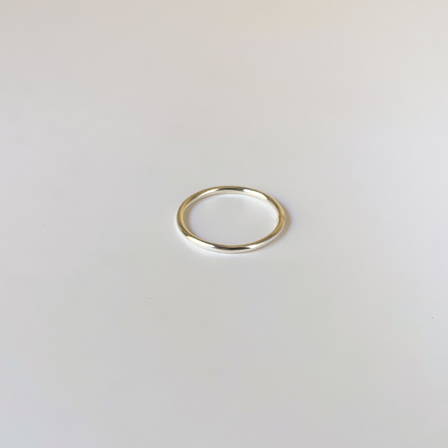Gold ring on a light gray background
